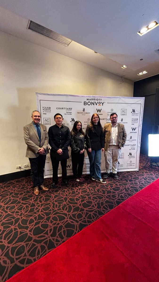 Grupo de la Escuela AHG UV frente al panel de marcas Marriott Bonvoy